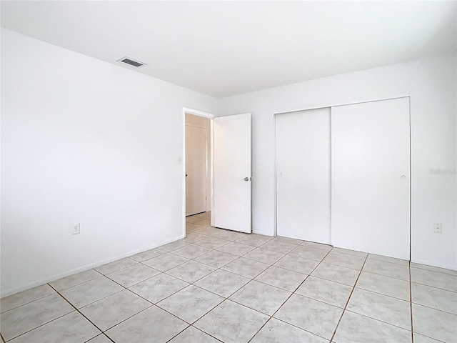 unfurnished bedroom featuring visible vents and a closet