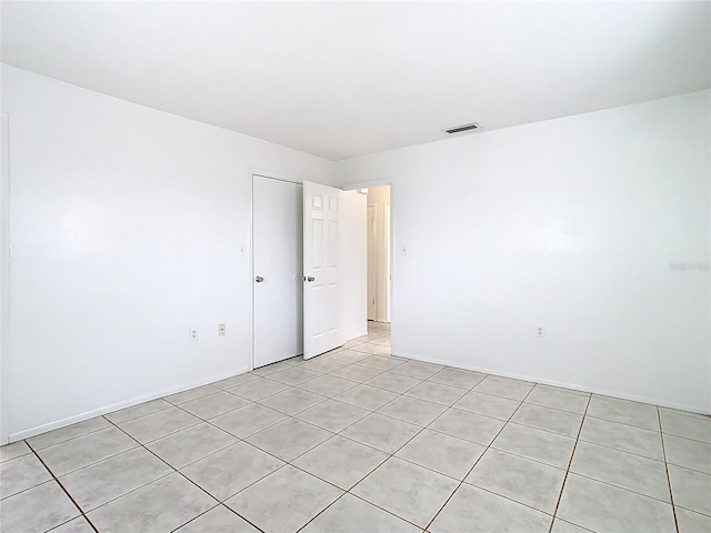 unfurnished room featuring visible vents