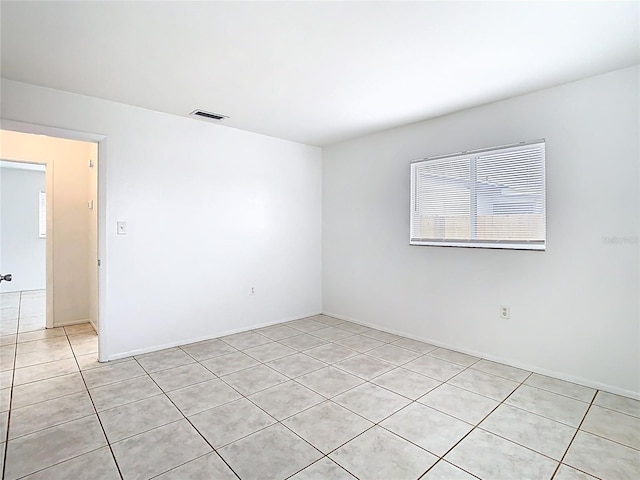 unfurnished room featuring visible vents