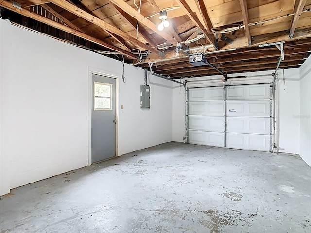 garage featuring electric panel and a garage door opener