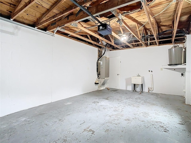 garage featuring a sink, heating unit, and a garage door opener