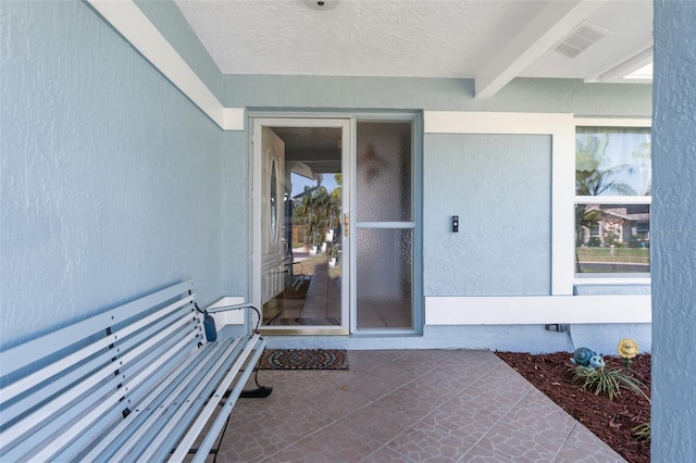 view of exterior entry featuring visible vents and crawl space