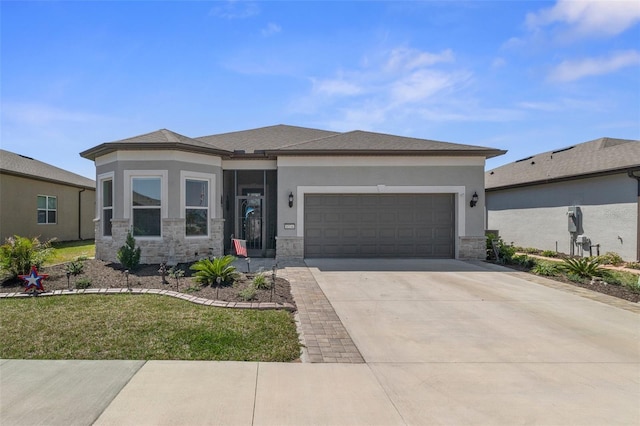 prairie-style home with an attached garage, stone siding, driveway, and stucco siding