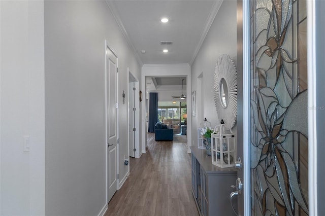 interior space with visible vents, crown molding, baseboards, recessed lighting, and wood finished floors