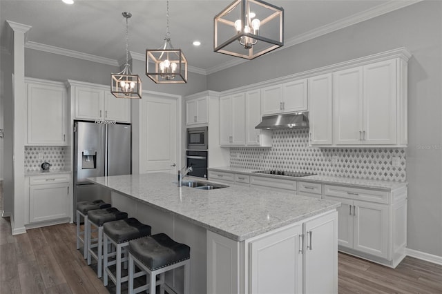 kitchen with under cabinet range hood, appliances with stainless steel finishes, white cabinets, and a sink