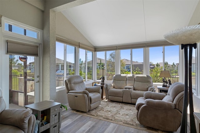 sunroom / solarium featuring plenty of natural light and vaulted ceiling