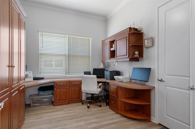 office area with light wood-style floors, built in desk, and ornamental molding