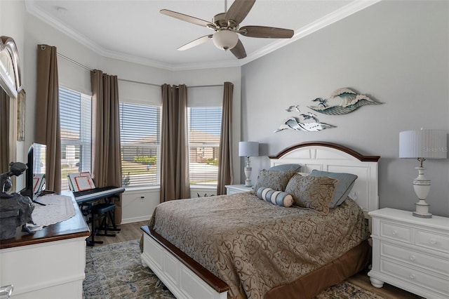 bedroom with ceiling fan, wood finished floors, and crown molding