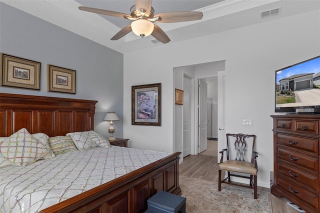 bedroom featuring a ceiling fan, visible vents, and light wood-type flooring