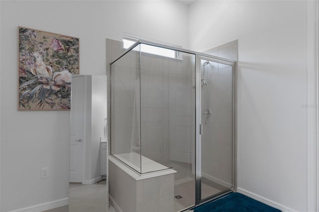 full bathroom featuring baseboards and a stall shower