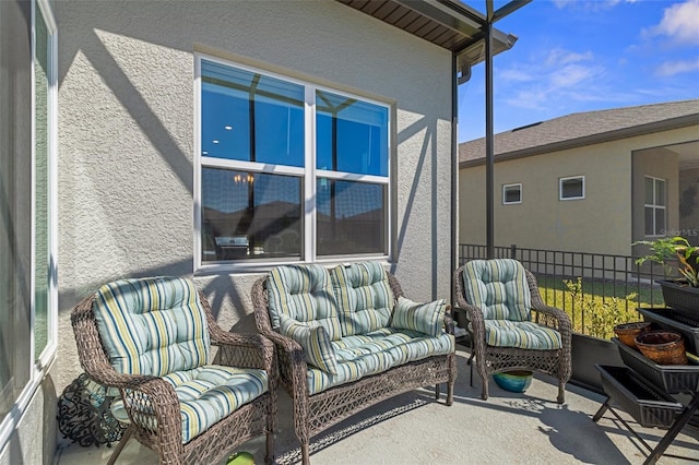 view of patio featuring outdoor lounge area and fence