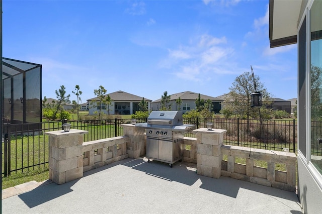 view of patio with a residential view, a lanai, and fence