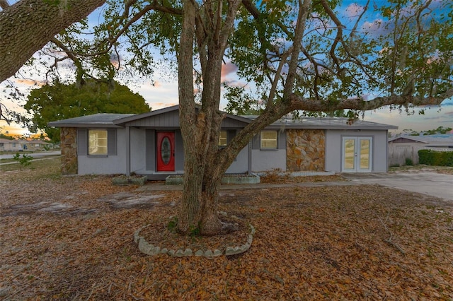 view of front facade with french doors and stone siding