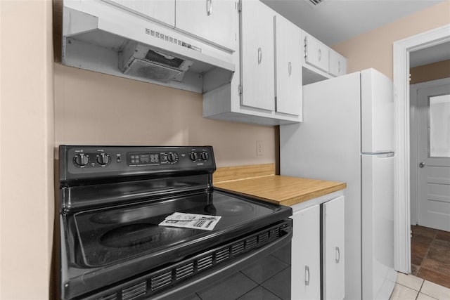 kitchen with under cabinet range hood, light countertops, freestanding refrigerator, black electric range, and white cabinets