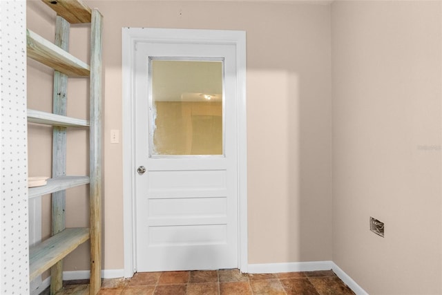 interior space featuring stone finish flooring and baseboards