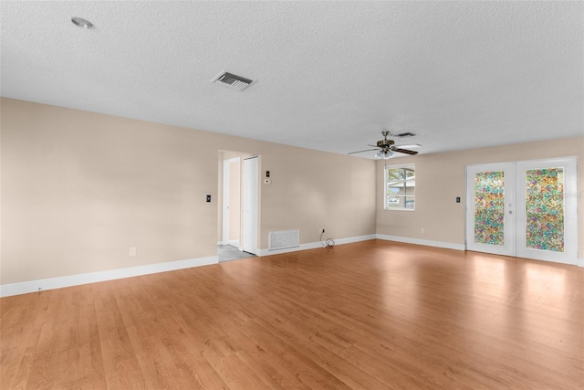 spare room with visible vents, baseboards, light wood-style flooring, and a ceiling fan