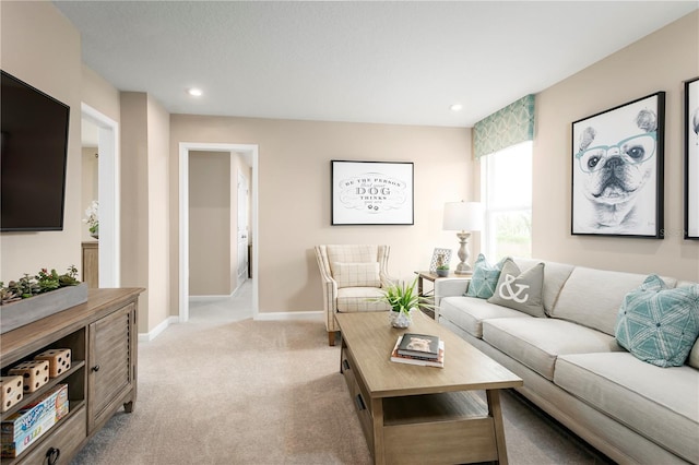 living room with recessed lighting, baseboards, and light colored carpet