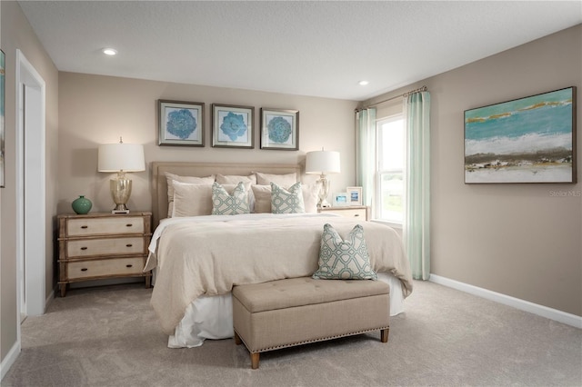 carpeted bedroom with recessed lighting, baseboards, and a textured ceiling