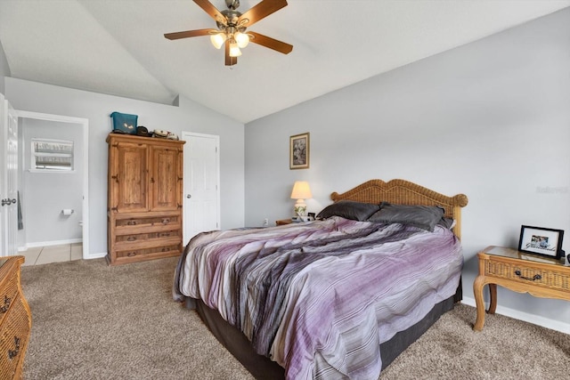 bedroom with a ceiling fan, baseboards, light tile patterned flooring, vaulted ceiling, and light colored carpet