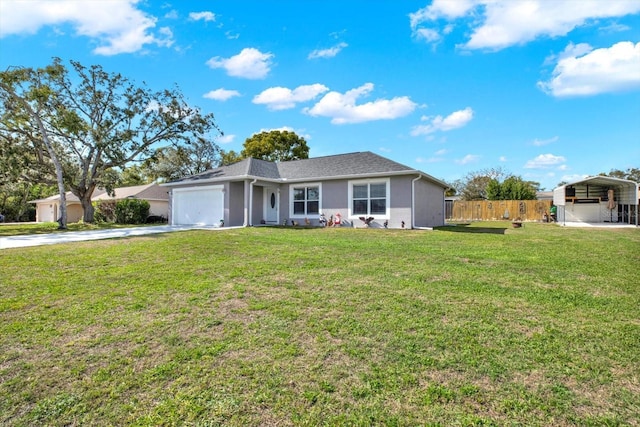 ranch-style home with driveway, fence, a detached carport, a front yard, and a garage