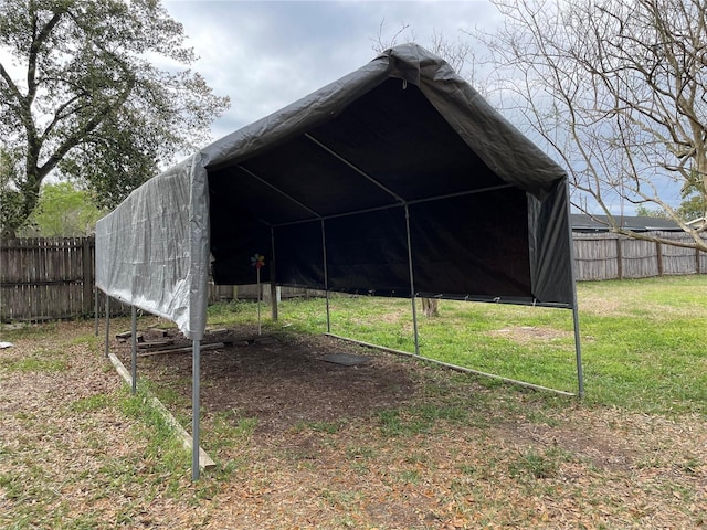 view of pole building with a yard and fence