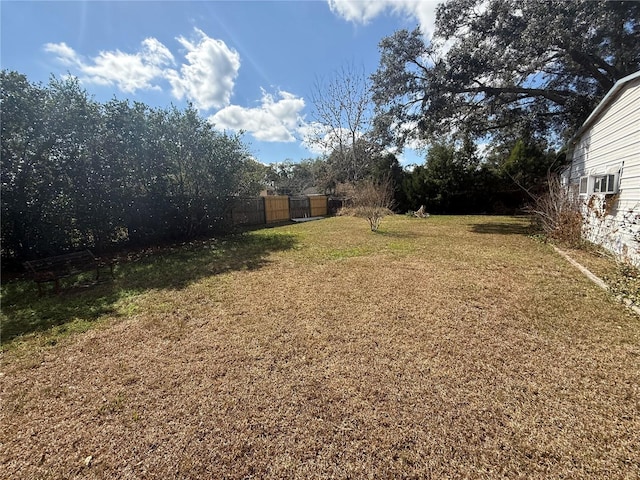 view of yard with cooling unit and fence