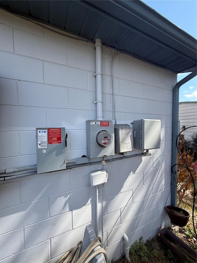 details featuring concrete block siding and electric meter