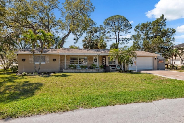 single story home with a garage, concrete driveway, a front lawn, and stucco siding