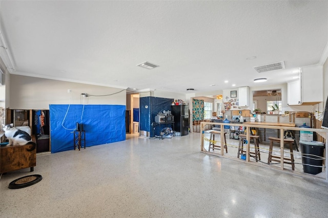 garage with visible vents and freestanding refrigerator