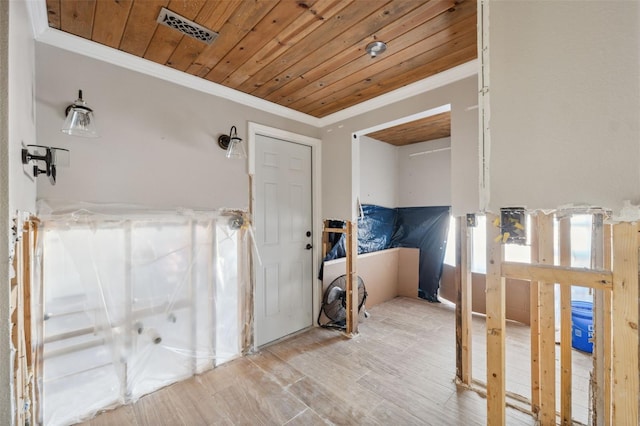 interior space with visible vents, wooden ceiling, wood finished floors, and ornamental molding