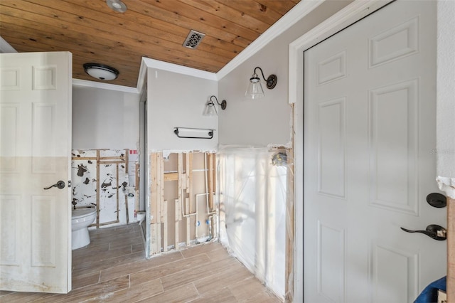 bathroom with visible vents, crown molding, wood finish floors, toilet, and wood ceiling