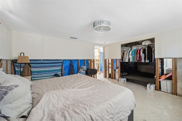 bedroom featuring a closet, visible vents, and speckled floor