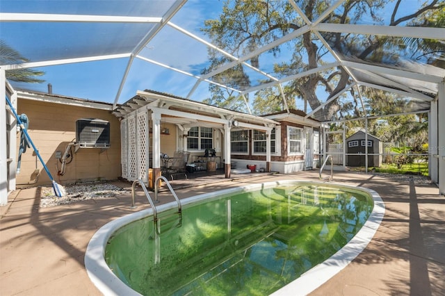 pool with glass enclosure, an outdoor structure, a patio area, and a shed