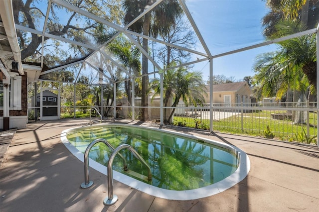 view of pool featuring fence, an outdoor structure, a storage unit, a lanai, and a patio area