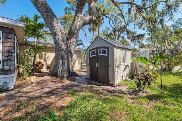 view of shed featuring fence