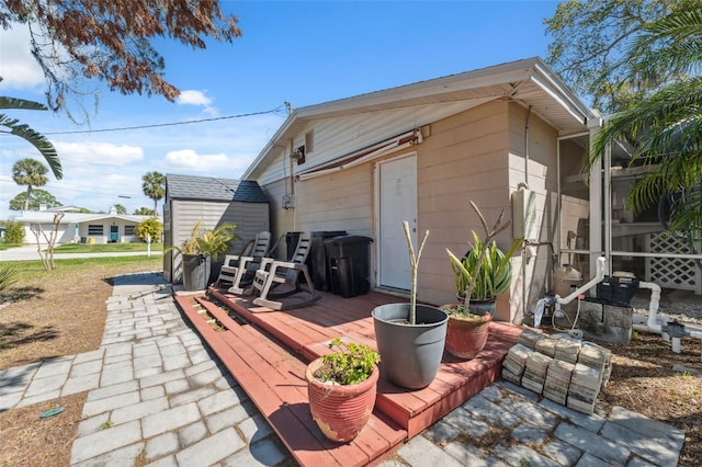 exterior space featuring a storage unit and an outbuilding