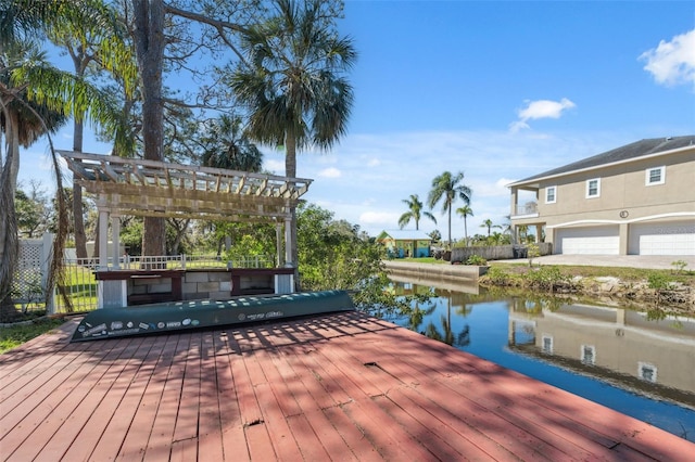 dock area with fence, a pergola, and a water view