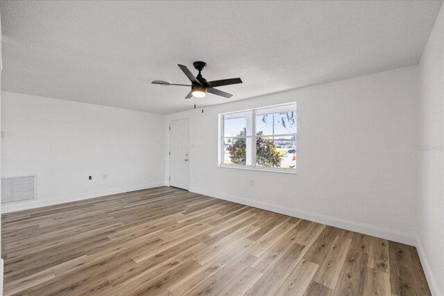 10841 Scenic Dr, Port Richey, FL 34668 - empty room with light wood-style flooring and ceiling fan