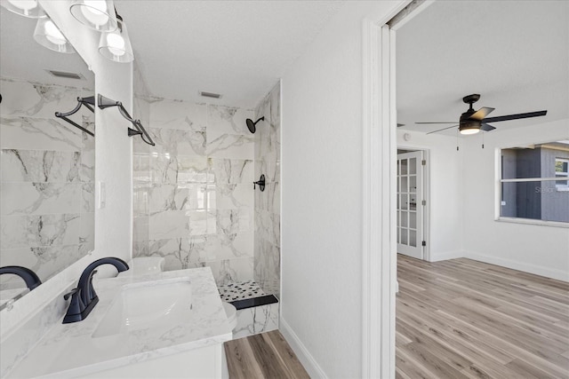 10841 Scenic Dr, Port Richey, FL 34668 - bathroom with a marble finish shower, vanity, wood finished floors, ceiling fan, and a textured ceiling