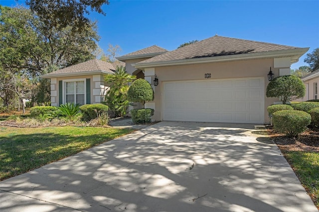 view of front facade featuring concrete driveway, a garage, roof with shingles, and stucco siding