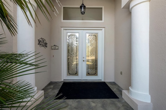 entrance to property with french doors and stucco siding