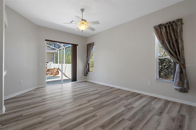 empty room with light wood-style flooring, baseboards, and ceiling fan