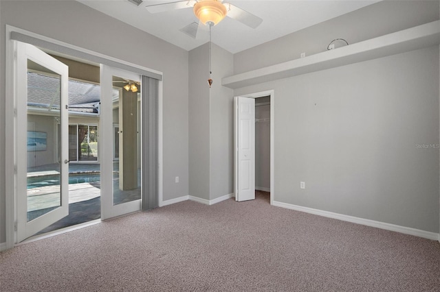 spare room featuring visible vents, carpet, baseboards, and ceiling fan