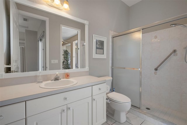 full bathroom featuring tile patterned floors, vanity, toilet, and a shower stall