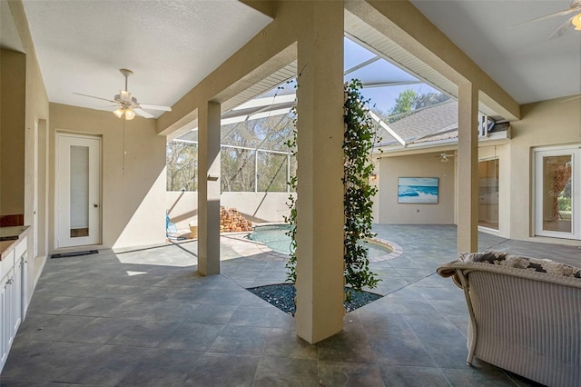 view of patio / terrace with a lanai, a fenced in pool, and ceiling fan