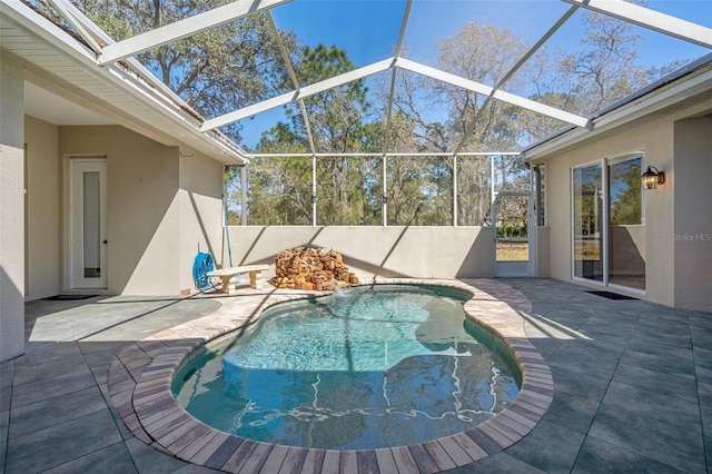 view of swimming pool with a lanai, a patio area, and a fenced in pool