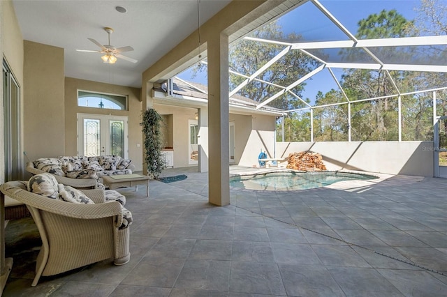 view of patio / terrace with glass enclosure, ceiling fan, a fenced in pool, and an outdoor hangout area