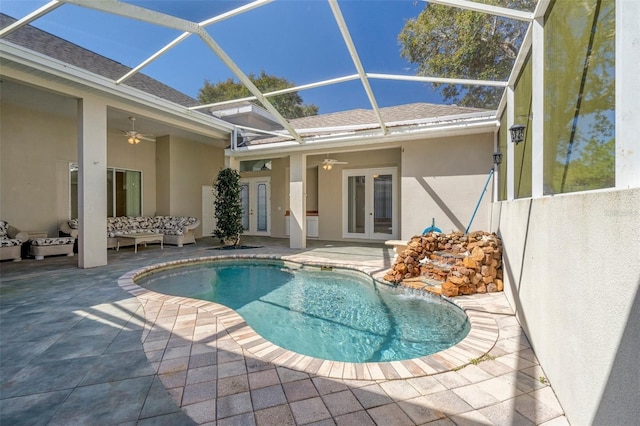 outdoor pool with french doors, a ceiling fan, outdoor lounge area, and a patio