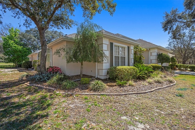 view of property exterior with a garage and stucco siding