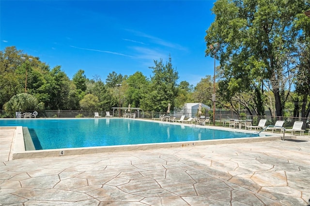 pool featuring a patio area and fence